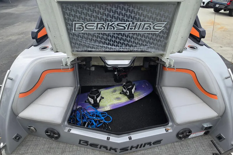 Slide: The Image of 2021 Berkshire 25 Sport CL DC 3.0+ boat interior with wakeboard and storage compartment. - 16