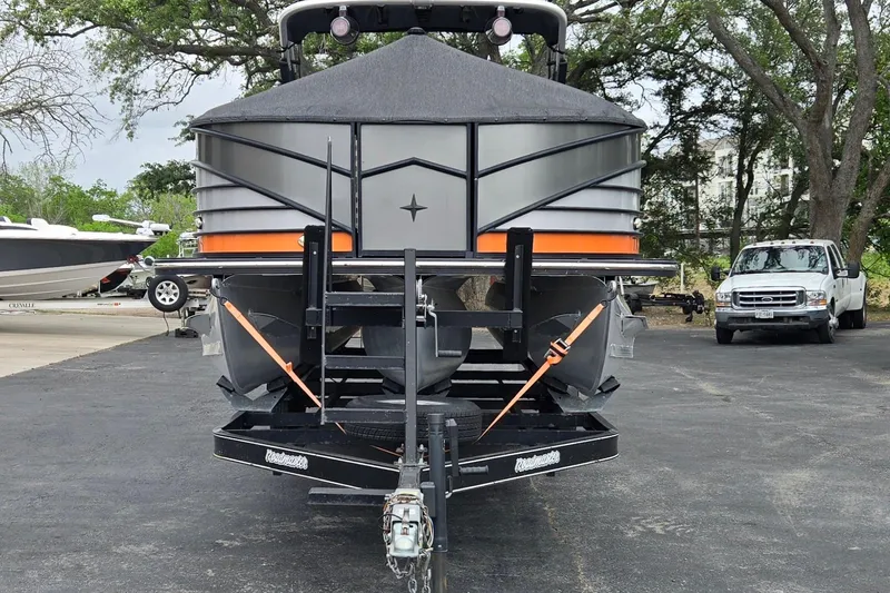 Slide: The Image of 2021 Berkshire 25 Sport CL DC 3.0+ pontoon boat on trailer, parked outdoors. - 30