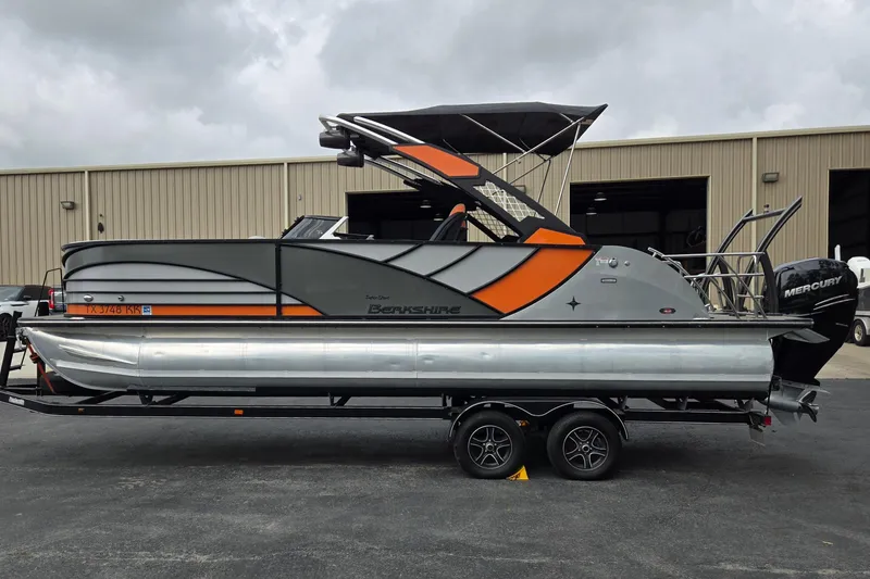 Slide: The Image of 2021 Berkshire 25 Sport CL DC 3.0+ pontoon boat on trailer, parked outside warehouse. - 6