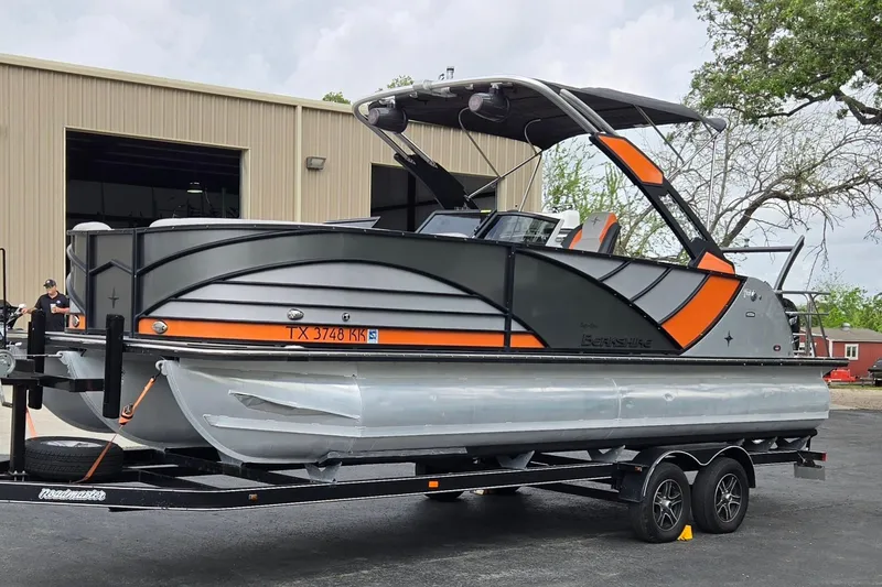 Slide: The Image of 2021 Berkshire 25 Sport CL DC 3.0+ pontoon boat on trailer, parked outside a building. - 7