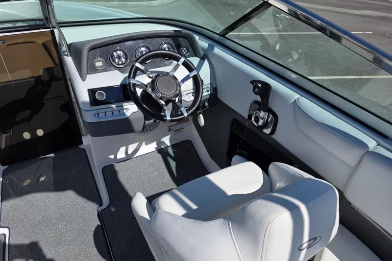 Slide: The Image of 2013 Regal 2500 Bowrider cockpit with steering wheel and controls, featuring modern design. - 15