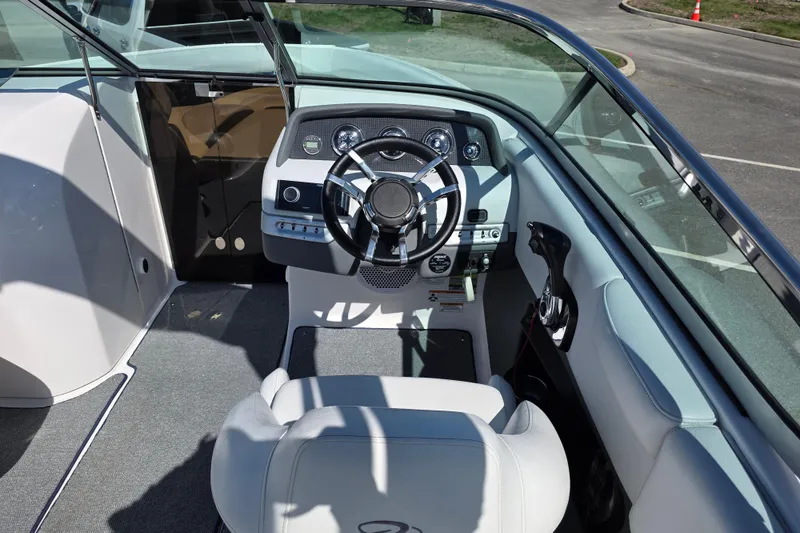 Slide: The Image of 2013 Regal 2500 Bowrider cockpit with steering wheel and dashboard controls. - 16