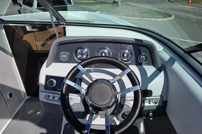 Slide: The Image of 2013 Regal 2500 Bowrider dashboard with steering wheel and instrument panel. - 17