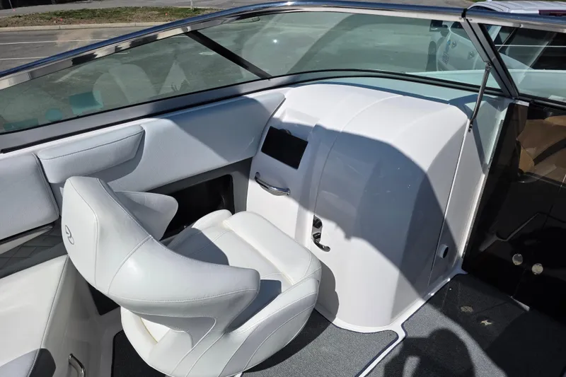 Slide: The Image of Interior of a 2013 Regal 2500 Bowrider boat, featuring a sleek white captain's chair. - 19