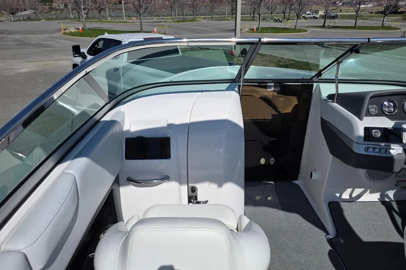 Slide: The Image of 2013 Regal 2500 Bowrider interior with white seating and dashboard view. - 20