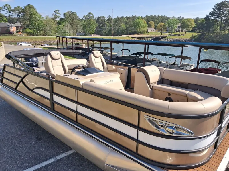 Slide: The Image of 2025 Bentley Pontoons Legacy 223 Swingback on a lake. - 2