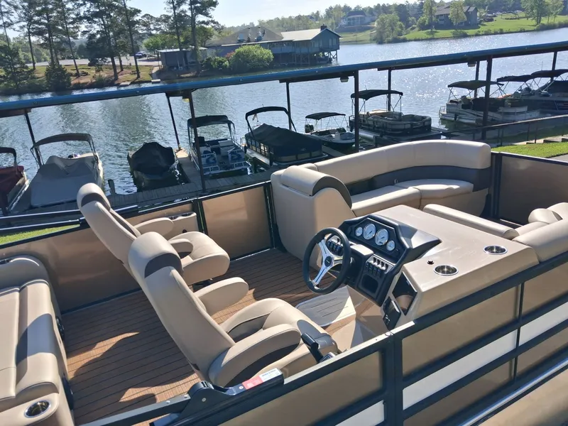 Slide: The Image of 2025 Bentley Pontoons Legacy 223 Swingback on a serene lake. - 6