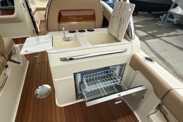 Slide: The Image of 2023 Chris-Craft Calypso 28 boat interior with sink, countertop, and storage drawer. - 10