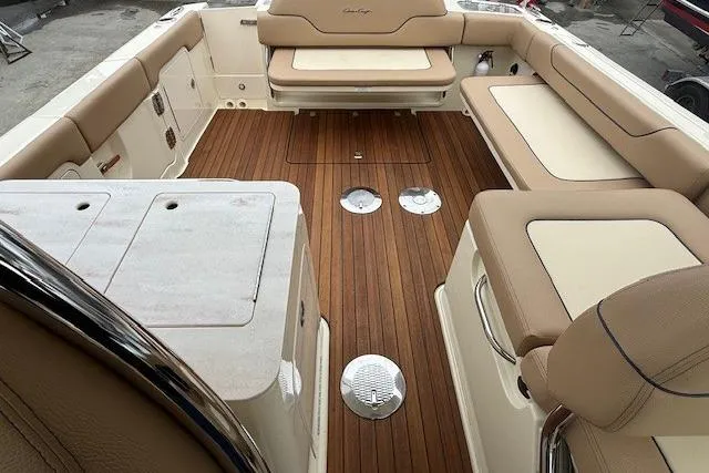 Slide: The Image of 2023 Chris-Craft Calypso 28 boat interior with teak flooring and beige seating. - 11
