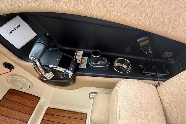 Slide: The Image of 2023 Chris-Craft Calypso 28 boat interior with control panel and Mercury throttle. - 12