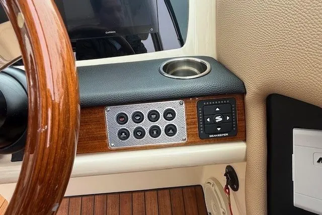 Slide: The Image of 2023 Chris-Craft Calypso 28 dashboard with wood accents and control panel. - 16