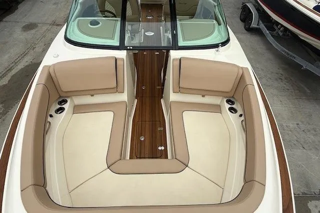 Slide: The Image of 2023 Chris-Craft Calypso 28 boat interior with beige seating and wooden flooring. - 20
