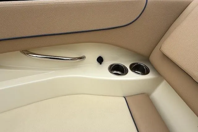 Slide: The Image of Interior detail of 2023 Chris-Craft Calypso 28 boat, featuring beige upholstery and cup holders. - 21