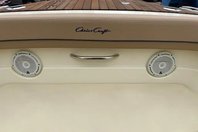 Slide: The Image of 2023 Chris-Craft Calypso 28 boat interior with speakers and wooden deck. - 22