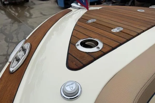 Slide: The Image of 2023 Chris-Craft Calypso 28 boat with elegant teak wood deck and chrome fittings. - 24