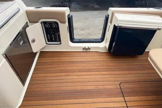 Slide: The Image of 2023 Chris-Craft Calypso 28 boat interior with teak flooring and control panel. - 28