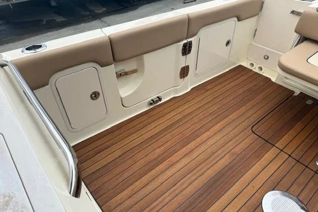 Slide: The Image of 2023 Chris-Craft Calypso 28 boat interior with teak flooring and storage compartments. - 29