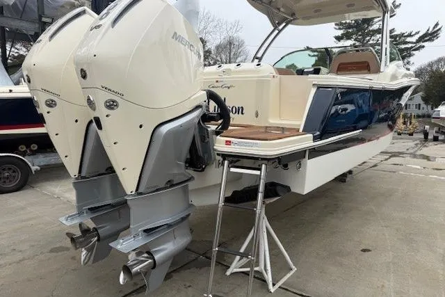 Slide: The Image of 2023 Chris-Craft Calypso 28 boat with dual Mercury Verado engines, docked on a concrete surface. - 3