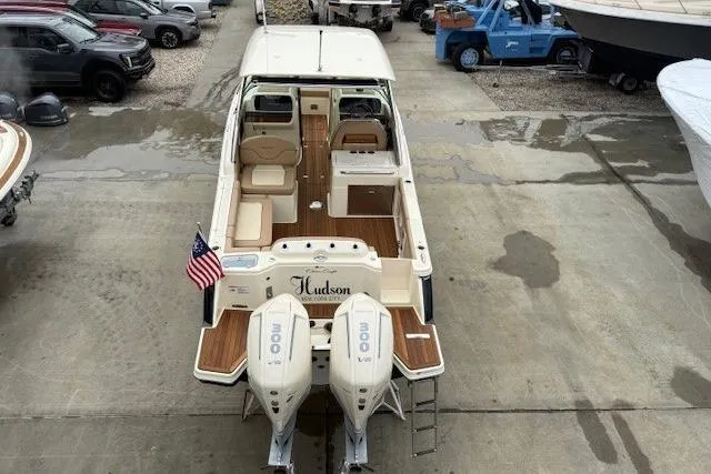 Slide: The Image of 2023 Chris-Craft Calypso 28 boat with twin engines, docked in a marina. - 4