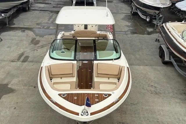 Slide: The Image of 2023 Chris-Craft Calypso 28 boat with elegant seating and wooden deck details. - 5