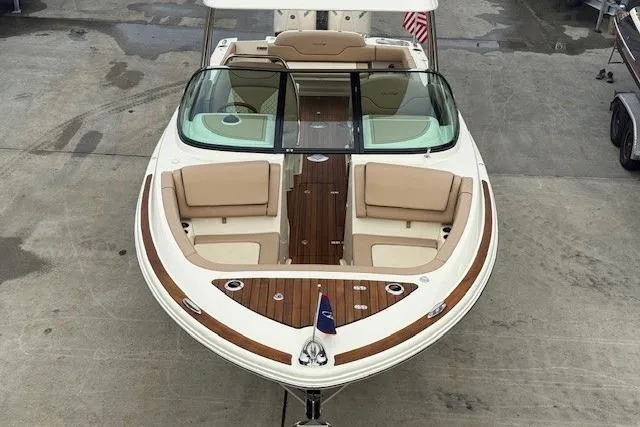 Slide: The Image of 2023 Chris-Craft Calypso 28 boat with elegant seating and wooden deck, viewed from above. - 6