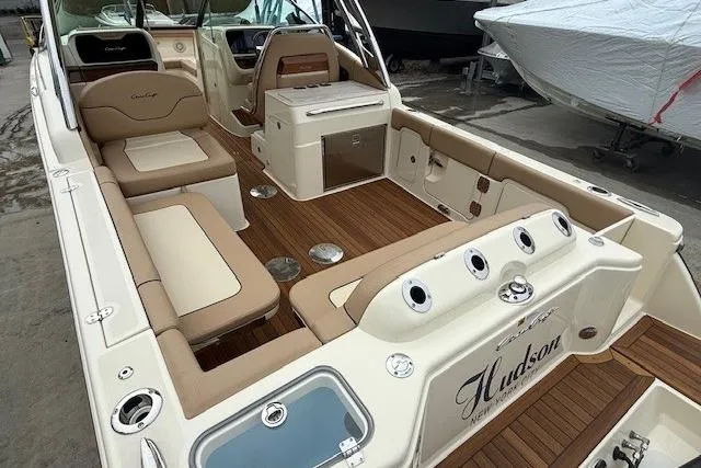 Slide: The Image of 2023 Chris-Craft Calypso 28 boat interior with luxurious seating and wood finish. - 9
