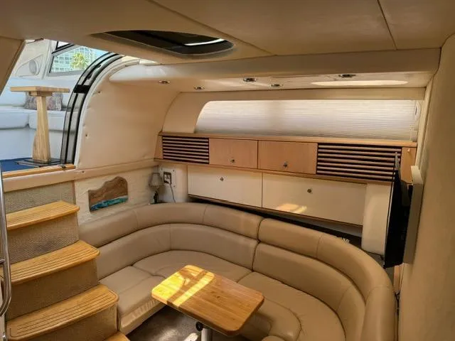 Slide: The Image of Interior of 1998 Bayliner 4085 Avanti Sunbridge with beige seating and wooden accents. - 12