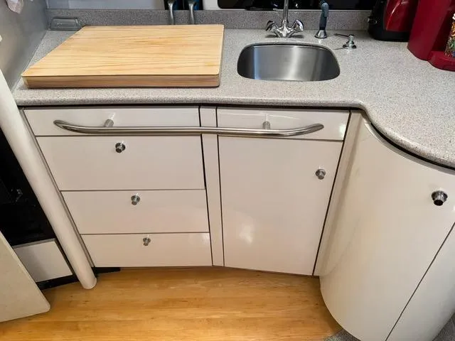 Slide: The Image of Compact kitchen area in a 1998 Bayliner 4085 Avanti Sunbridge boat. - 16