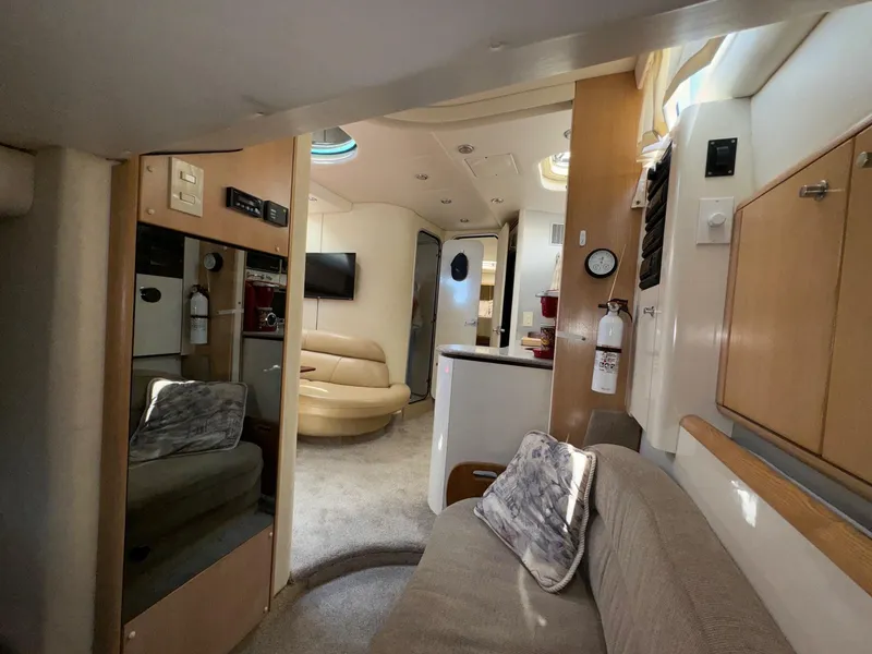 Slide: The Image of Interior of 1998 Bayliner 4085 Avanti Sunbridge yacht, featuring cozy seating and modern amenities. - 17