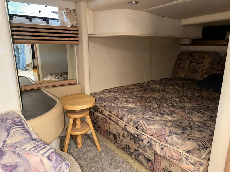 Slide: The Image of 1998 Bayliner 4085 Avanti Sunbridge cabin interior with bed, stool, and window. - 18