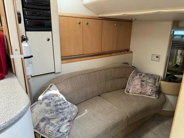 Slide: The Image of Interior of 1998 Bayliner 4085 Avanti Sunbridge with beige sofa and wooden cabinets. - 21