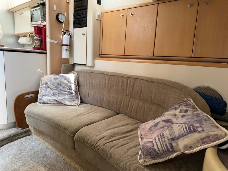 Slide: The Image of Interior of 1998 Bayliner 4085 Avanti Sunbridge with beige sofa and wooden cabinets. - 22