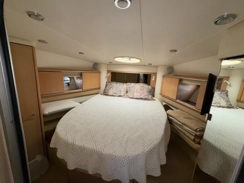 Slide: The Image of 1998 Bayliner 4085 Avanti Sunbridge cabin with cozy bed and modern interior design. - 25