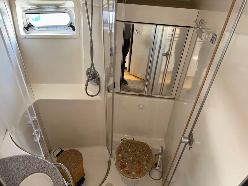 Slide: The Image of Bathroom interior of 1998 Bayliner 4085 Avanti Sunbridge yacht, featuring shower and toilet. - 26