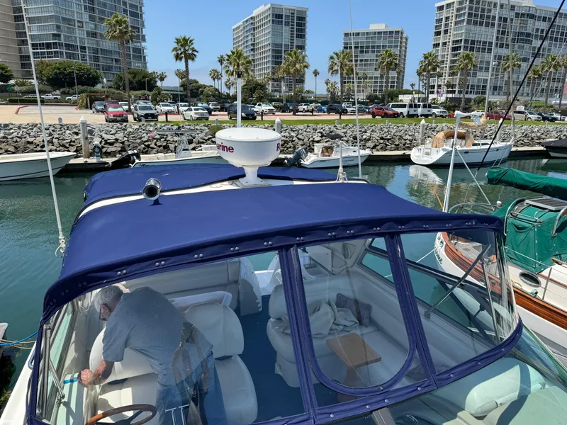 Slide: The Image of 1998 Bayliner 4085 Avanti visiting intown marina with cityscape background. - 33