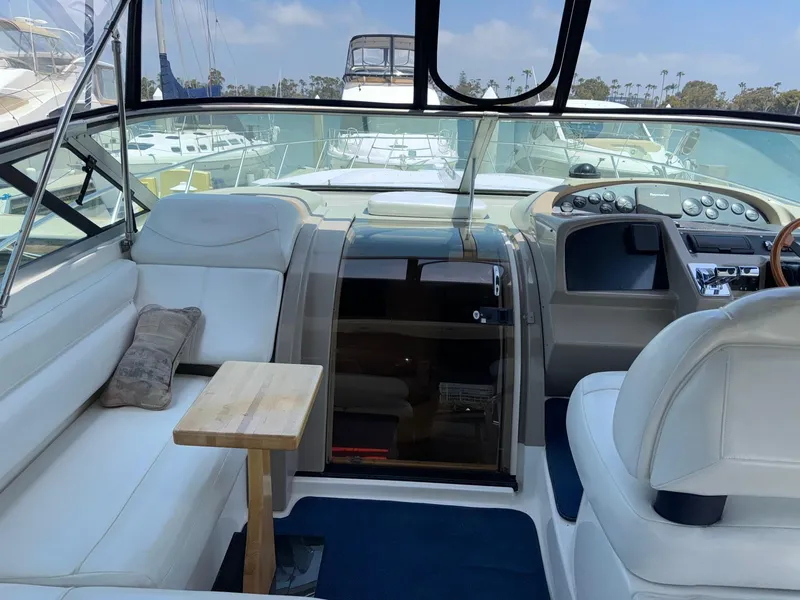 Slide: The Image of 1998 Bayliner 4085 Avanti Sunbridge interior with white seating and wooden table. - 35