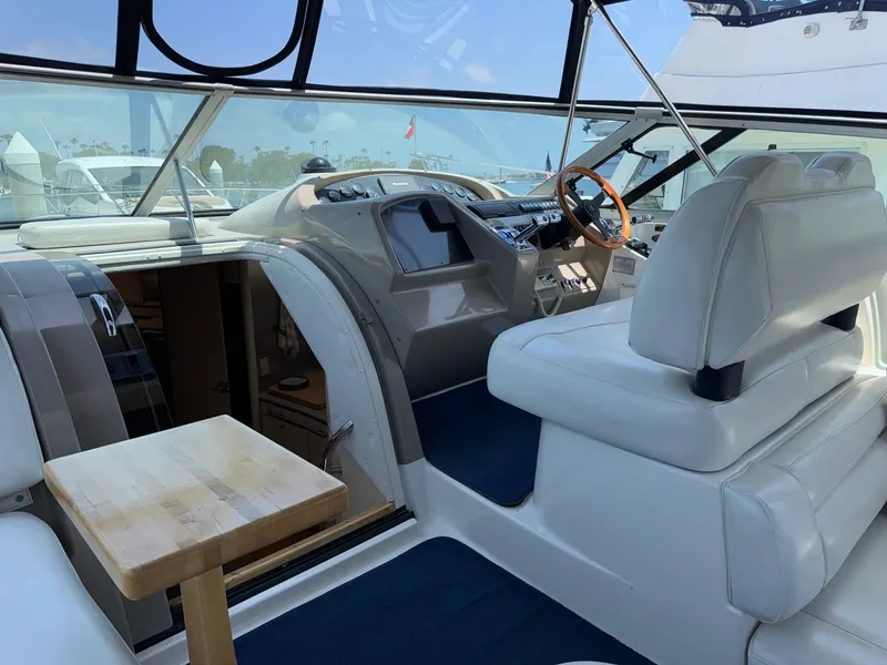 Slide: The Image of 1998 Bayliner 4085 Avanti Sunbridge interior with helm, seating, and wooden table. - 36