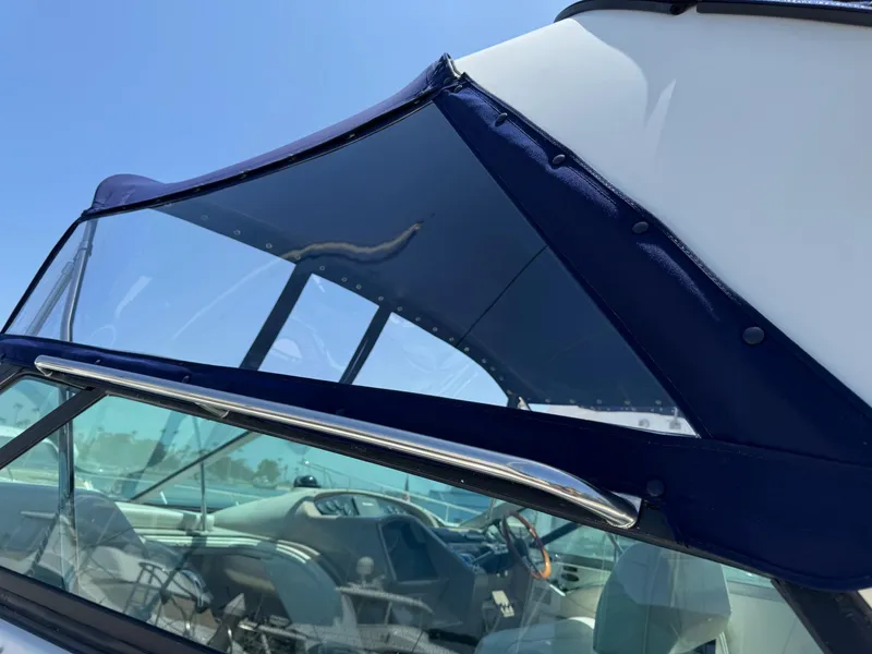 Slide: The Image of 1998 Bayliner 4085 Avanti Sunbridge boat with blue canopy and clear windshield. - 39