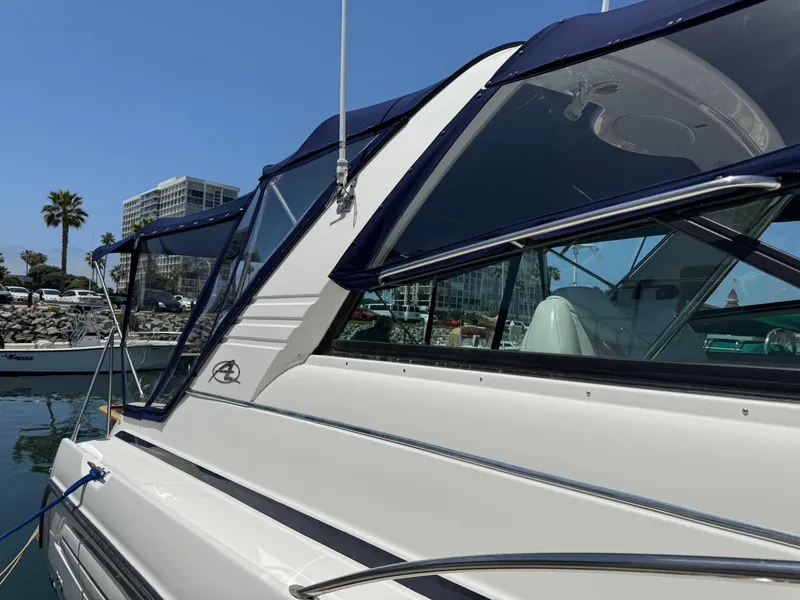 Slide: The Image of 1998 Bayliner 4085 Avanti Sunbridge yacht docked in a marina, clear blue sky. - 40