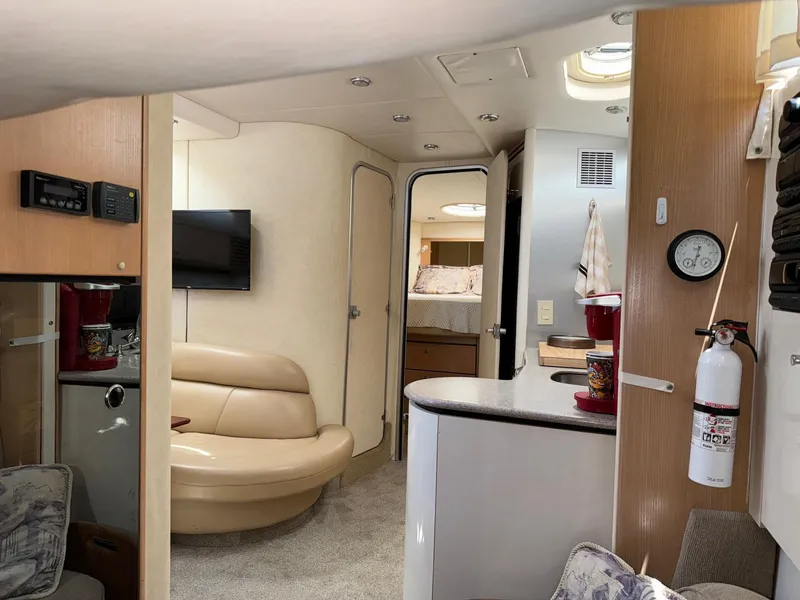 Slide: The Image of Interior of 1998 Bayliner 4085 Avanti Sunbridge yacht, featuring modern amenities and cozy seating. - 9