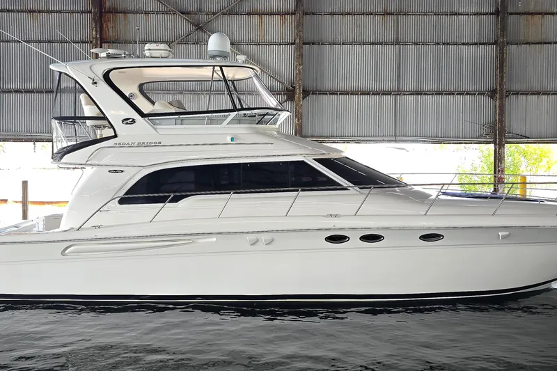 The Image of 2004 Sea Ray 480 Sedan Bridge yacht docked in a covered marina. - 0