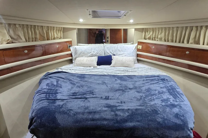 Slide: The Image of Luxurious bedroom interior of 2004 Sea Ray 480 Sedan Bridge yacht with plush bedding. - 10