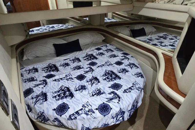 Slide: The Image of Luxurious 2004 Sea Ray 480 Sedan Bridge cabin with nautical-themed bedding. - 12