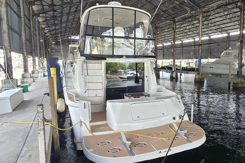 Slide: The Image of 2004 Sea Ray 480 Sedan Bridge yacht docked in a covered marina. - 13