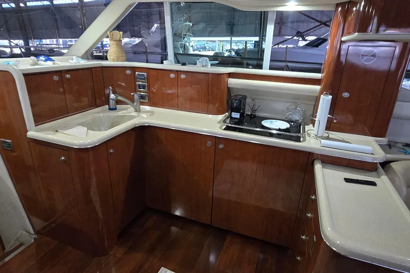 Slide: The Image of Luxurious kitchen interior of 2004 Sea Ray 480 Sedan Bridge yacht with wooden cabinetry. - 5