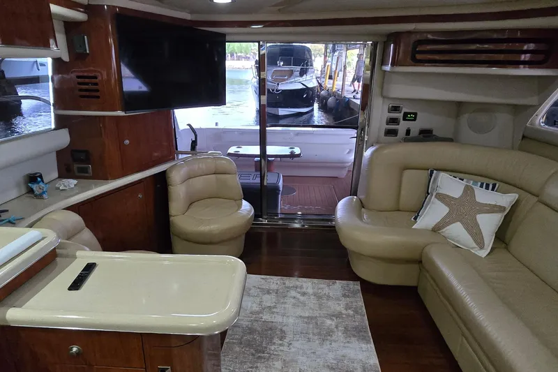 Slide: The Image of Interior of 2004 Sea Ray 480 Sedan Bridge yacht with luxurious seating and modern amenities. - 7