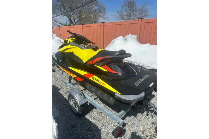 Slide: The Image of 2015 Sea-Doo GTR 215 jet ski on trailer, vibrant yellow and black design. - 3
