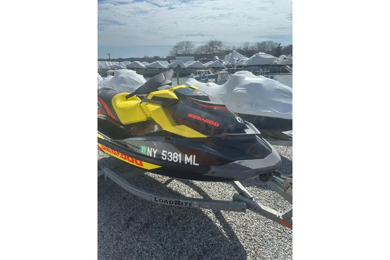 Slide: The Image of 2015 Sea-Doo GTR 215 jet ski on trailer, parked outdoors. - 7
