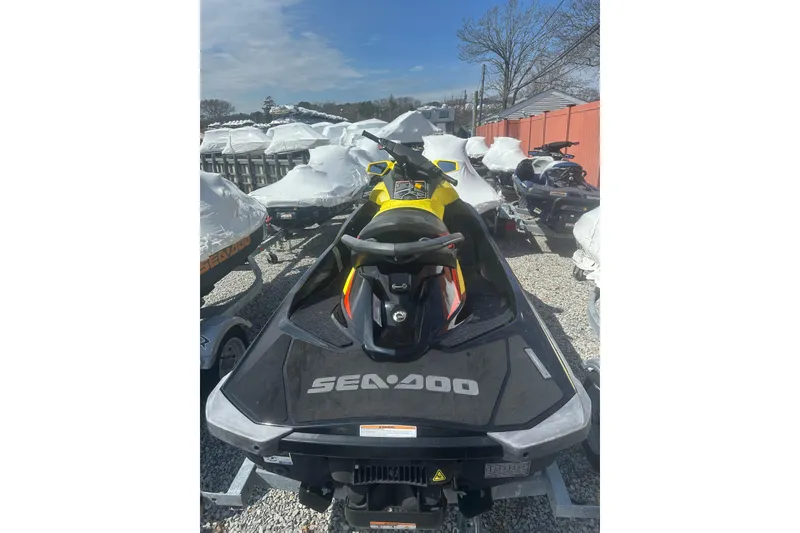 Slide: The Image of 2015 Sea-Doo GTR 215 jet ski in storage, surrounded by covered boats. - 8