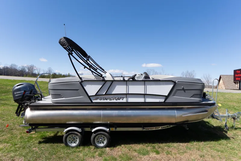 Slide: The Image of 2026 Starcraft GX 20 R DH pontoon boat on trailer, side view, outdoors. - 1